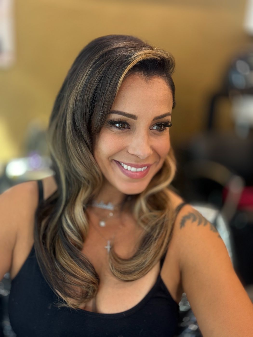 Smiling client with blended blonde balayage waves