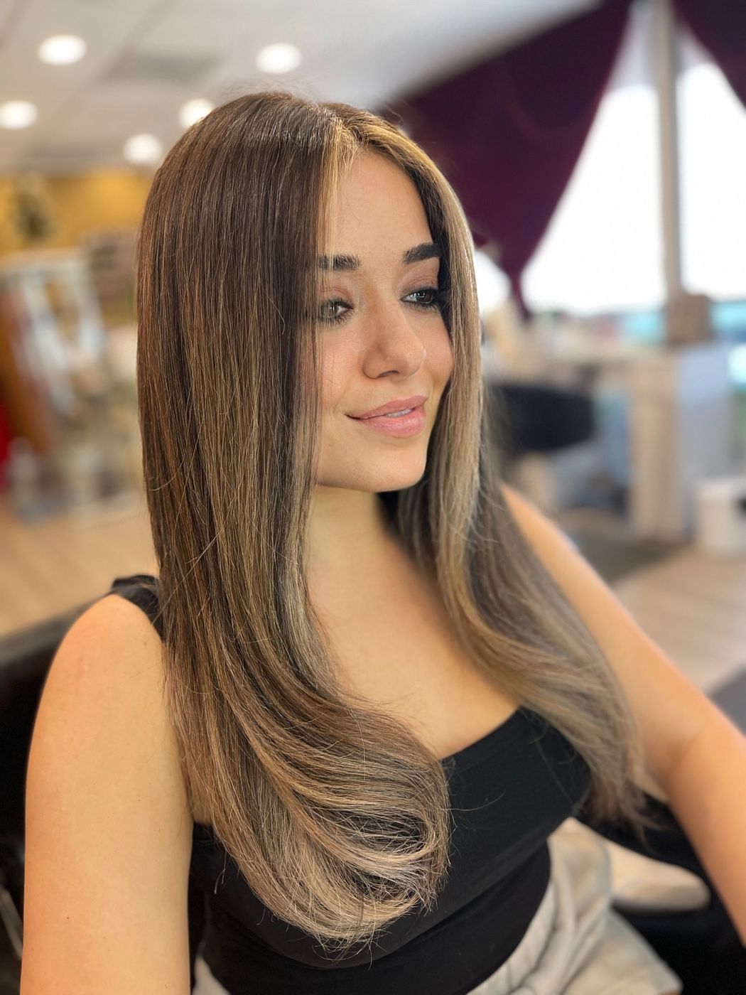 Client with glossy brunette color and subtle highlights