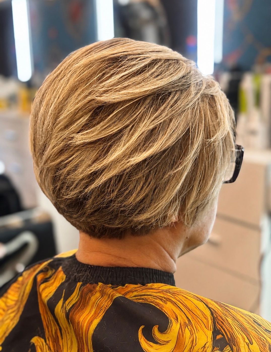 Feathered short blonde crop showing precise layering