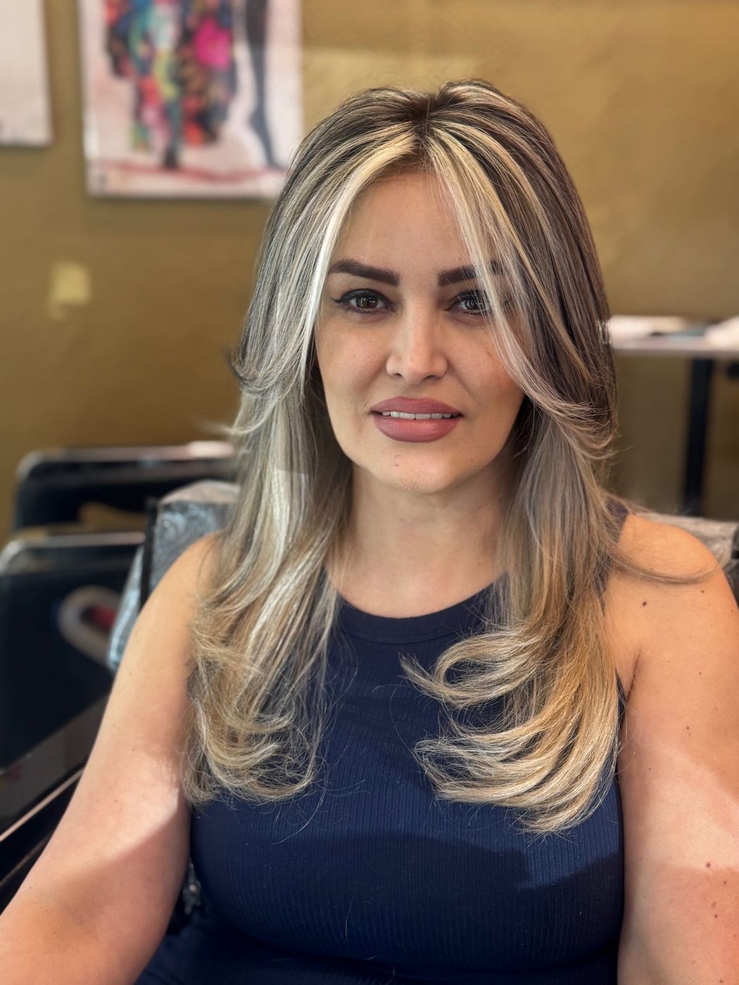 Client with platinum face-framing highlights on dark hair