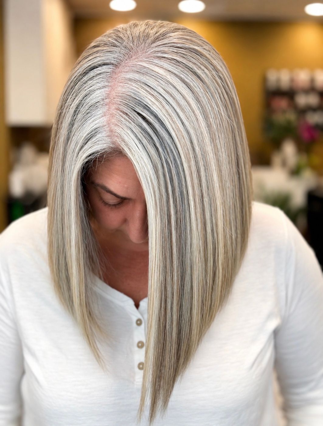 Long silver and gray blended hair with bright blonde highlights